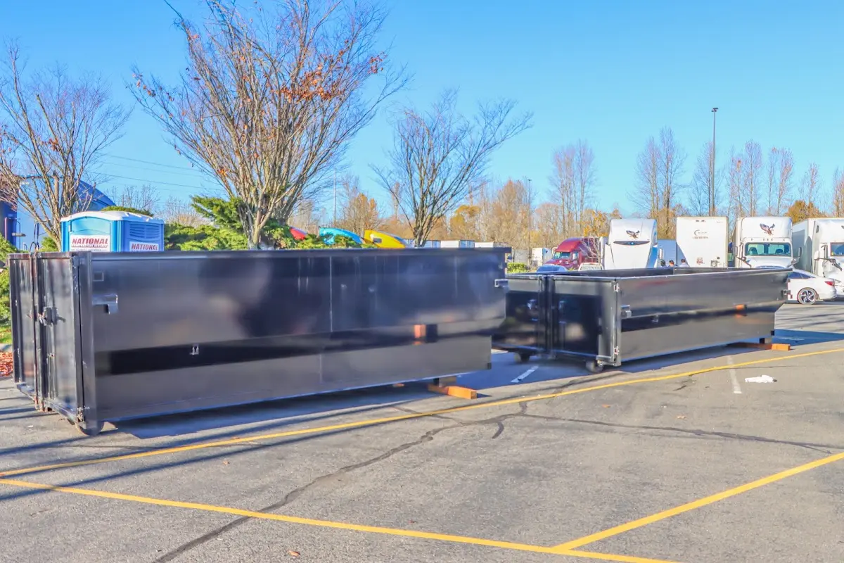 Professional dumpster rental service with roll-off container on residential driveway in Mocksville